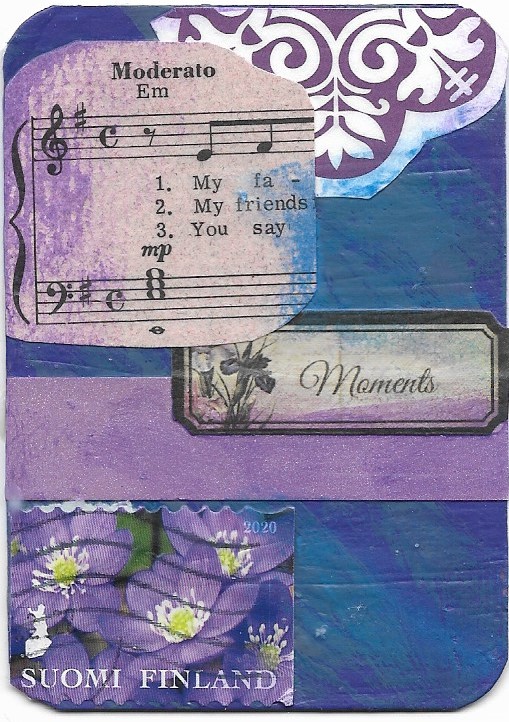 An artist trading card with an image of sheet music and the word "Moments"
